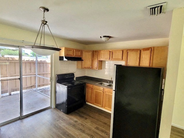 kitchen with pendant lighting and double sliding glass doors