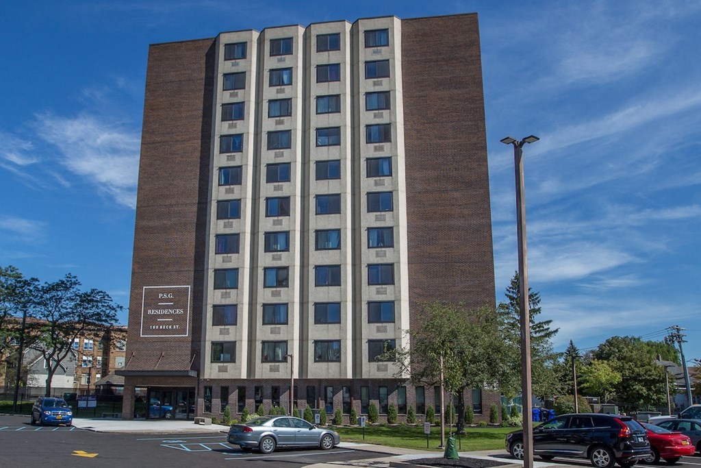 the exterior of Piotr Stadnitski Gardens and parking lot with cars in it