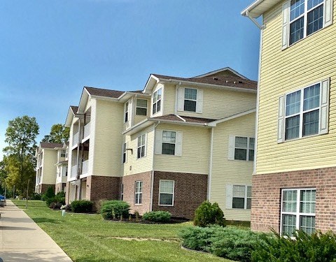 lush landscaping with brick and siding facades of marion green apartments
