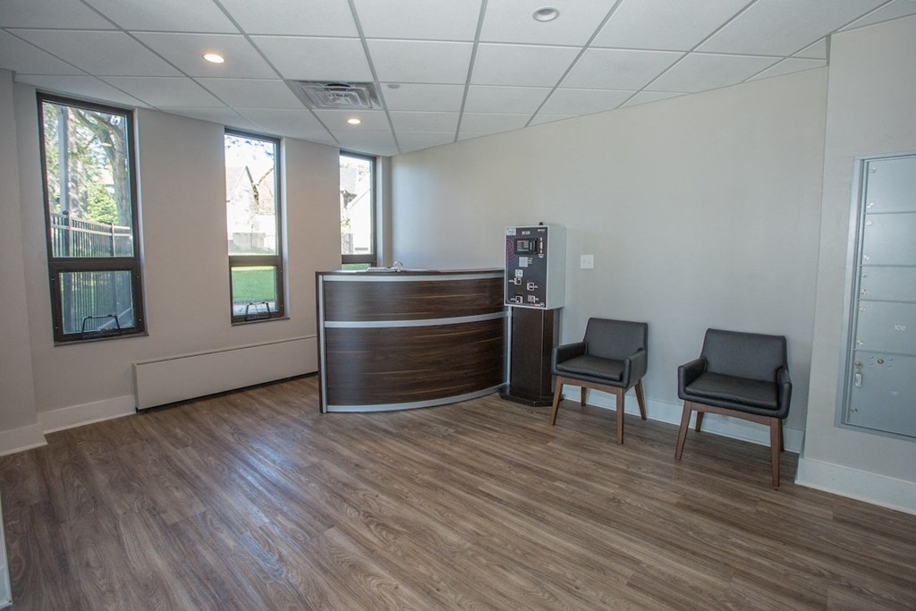 a customer service desk in the lobby at Piotr Stadnitski Gardens Senior Apartments