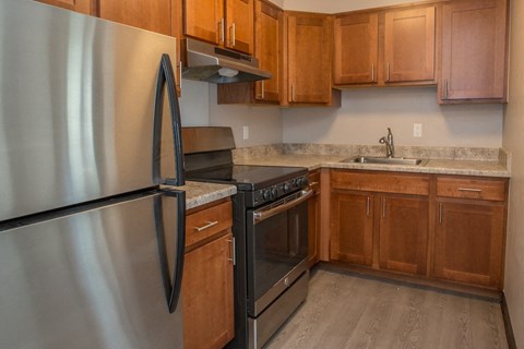 a kitchen with stainless steel appliances and wooden cabinets