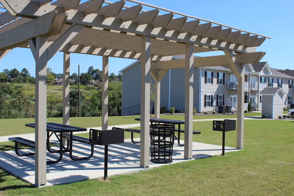 Pergola with picnic tables and grills