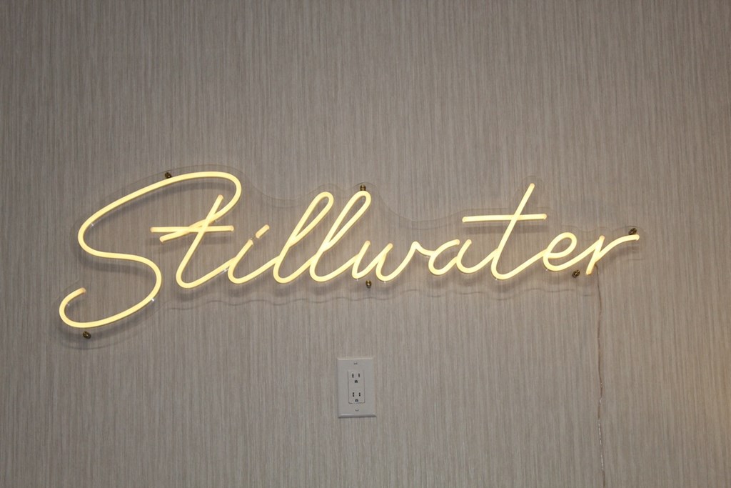 a neon sign that reads Stillwater in clubhouse at Stillwater at Grandview Cove