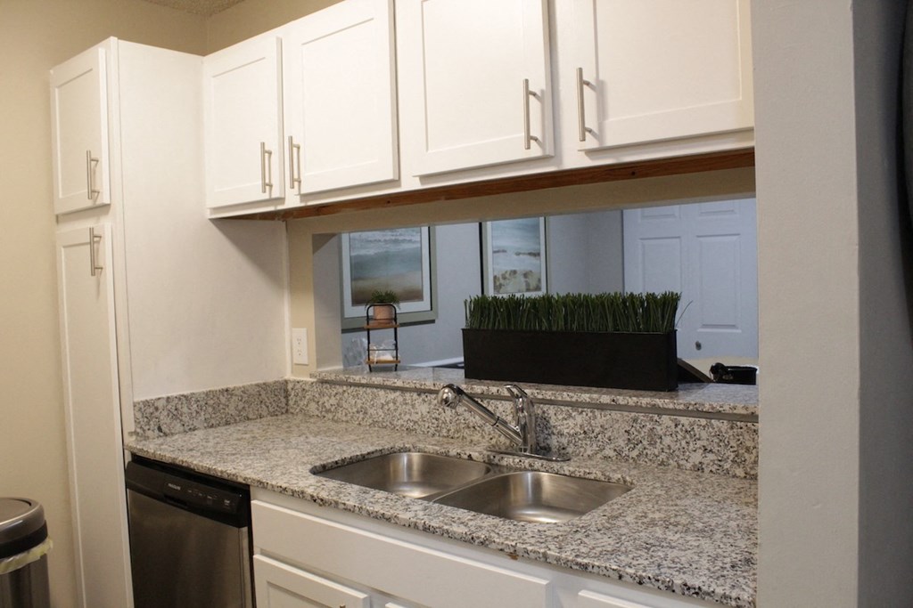 Stillwater apartment kitchen with white cabinets and granite countertops