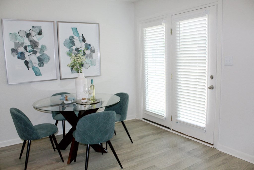 hardwood-style floor in dining area with double doors leading to deck  at Huntsville Landing Apartments, Huntsville, 35806