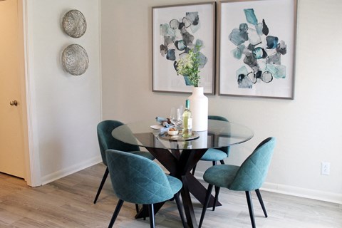 dining room with hardwood-style flooring, model dining set, and wall decor  at Huntsville Landing Apartments, Huntsville, AL, 35806