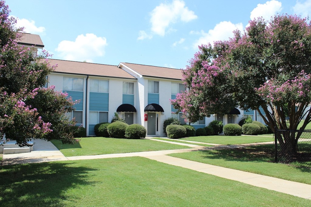lush courtyard with sidewalk, fenced dog park, and lush landscaping  at Huntsville Landing Apartments, Huntsville
