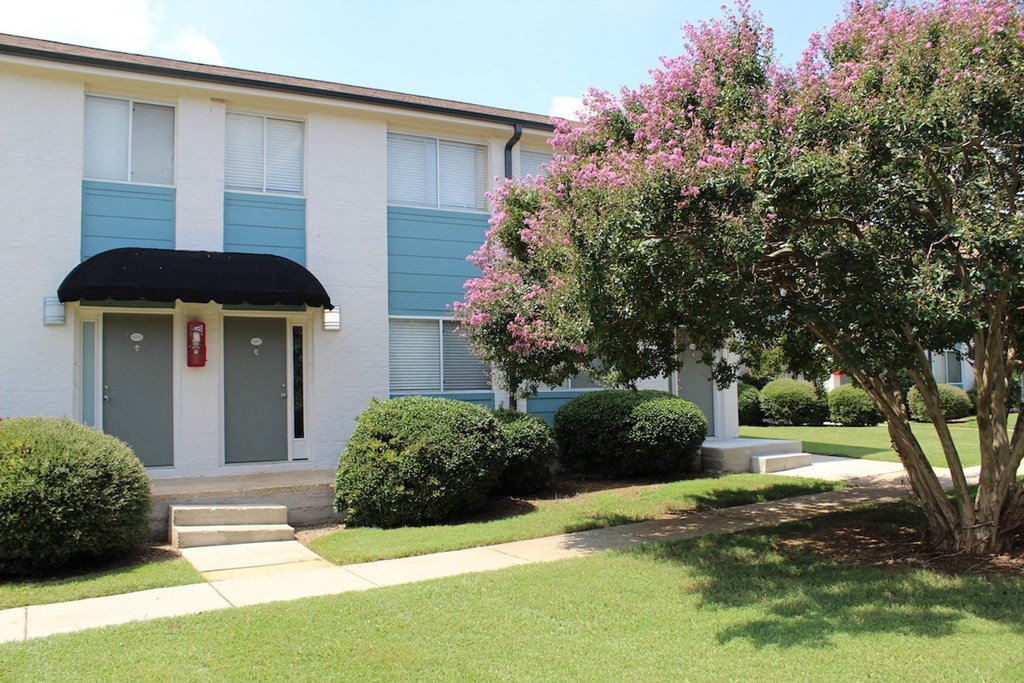 crepe myrtles blooming in front of Sherwood Park Apartments in Huntsville  at Huntsville Landing Apartments, Huntsville, Alabama