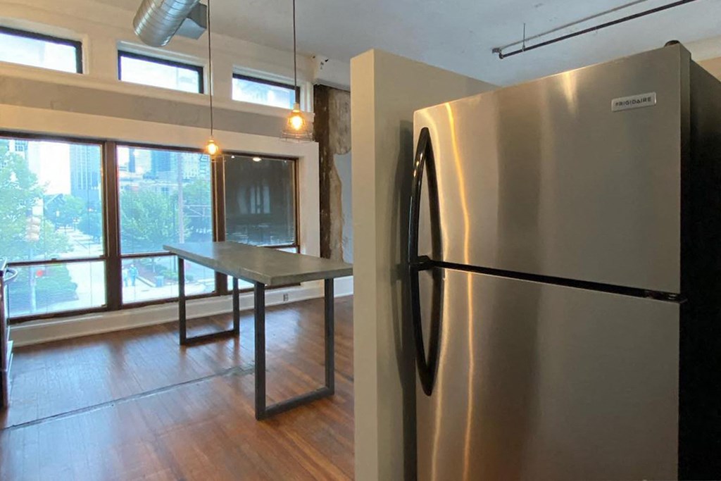 large stainless steel fridge, concrete island, and hardwood floors at Jemison Flats, Alabama