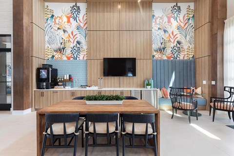 A modern dining room with a wooden table and chairs.