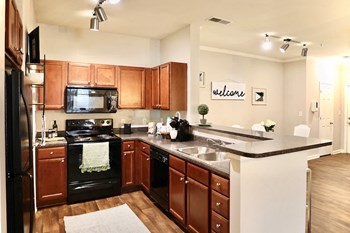 Kitchen-Gallery1 kitchen with black appliances, ample cabinetry and eat-in bar - Photo Gallery 6