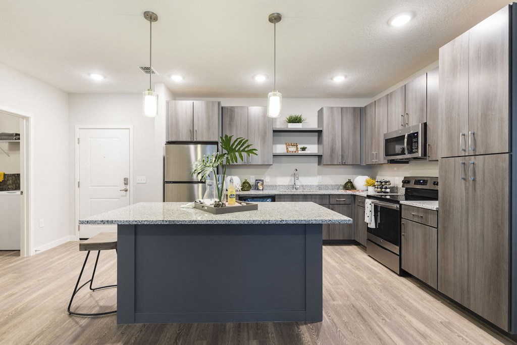 kitchen with granite topped island and modern cabinetry at Residences at The Green in Florida