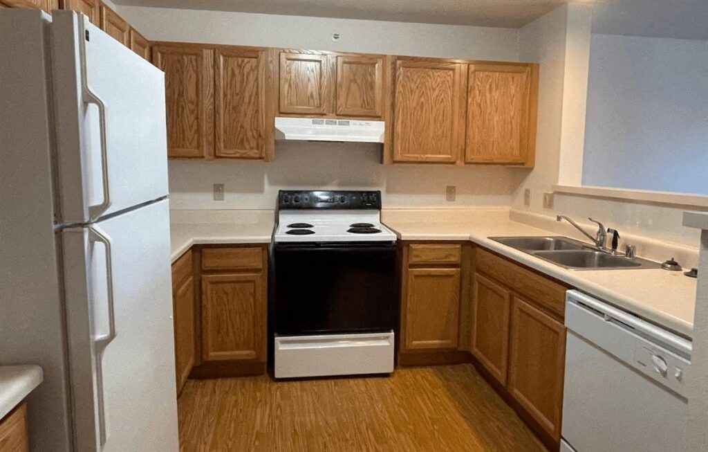 wooden cabinets and white appliances in a home at Algonquin Manor