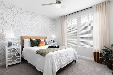 a bedroom with a bed and a large window
