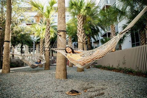Two people relaxing in the hammocks at LandonHouse in Lake Nona, Orlando, FL 32827