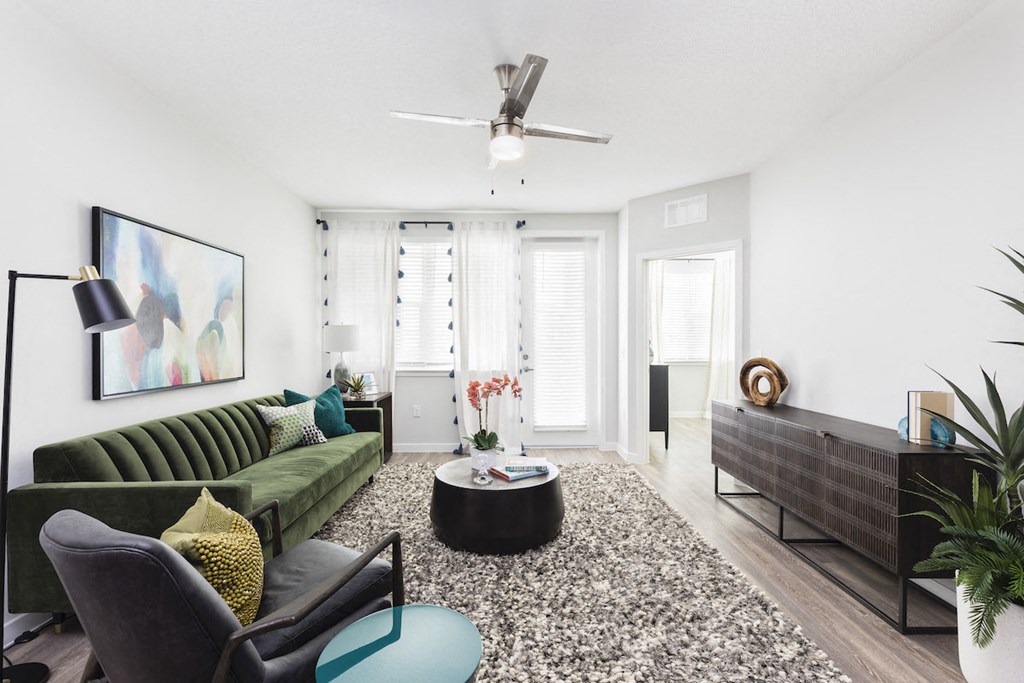 Spacious living room with large windows and natural lighting at Residences at The Green in Lakewood Ranch