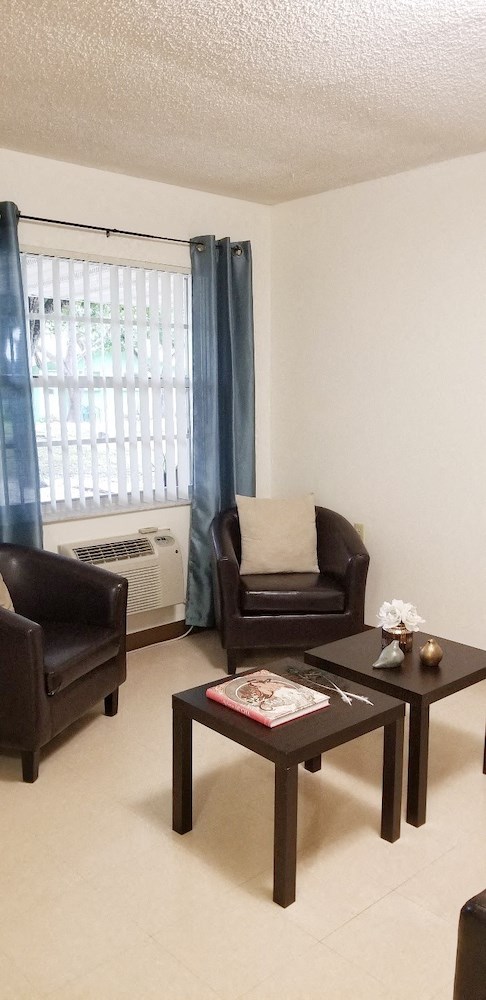 living room with large window and furnishings