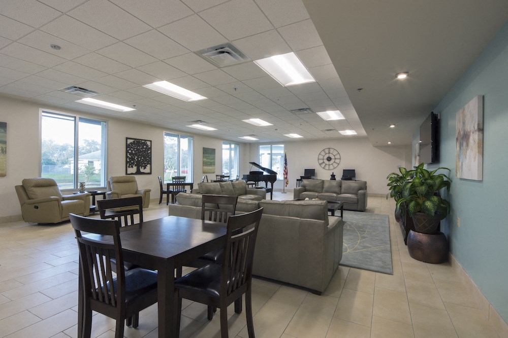 Mount Carmel Gardens senior apartments in jacksonville, florida community room with grand piano