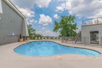 the pool and sundeck with loungers at Mountainside Apartments in Birmingham, AL