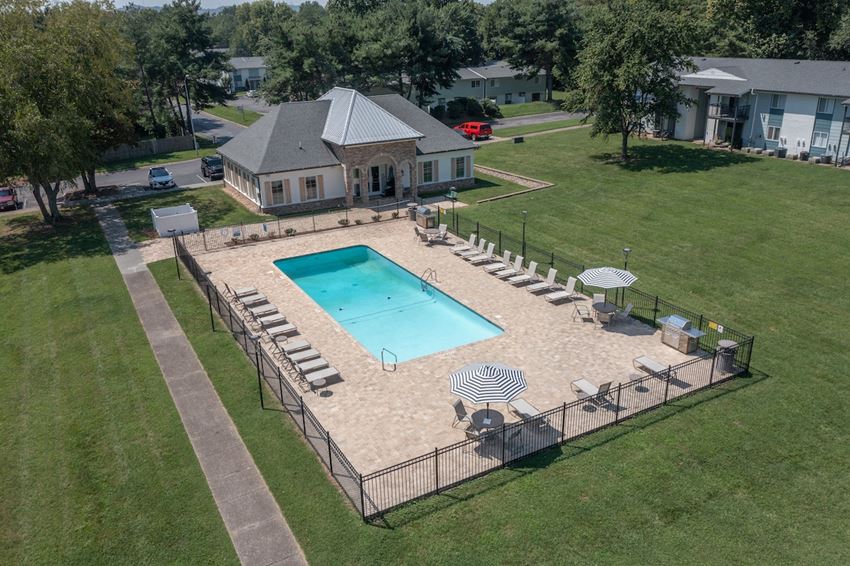 an aerial view of a swimming pool with a house in the background an aerial view of a swimming pool with a house in the background at The Madison Franklin, Franklin, Tennessee