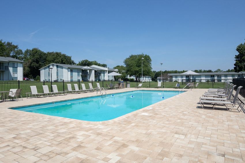 a large swimming pool with lounge chairs and umbrellas around it a large swimming pool with lounge chairs and umbrellas around it at The Madison Franklin, Franklin