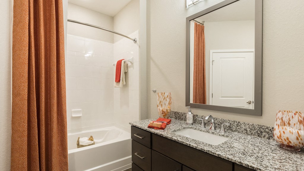 Spacious master bathroom with granite countertops