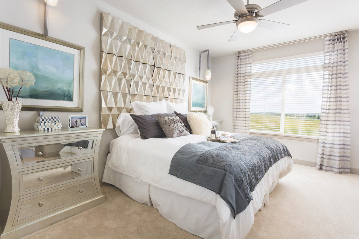Furnished model bedroom with plush carpet