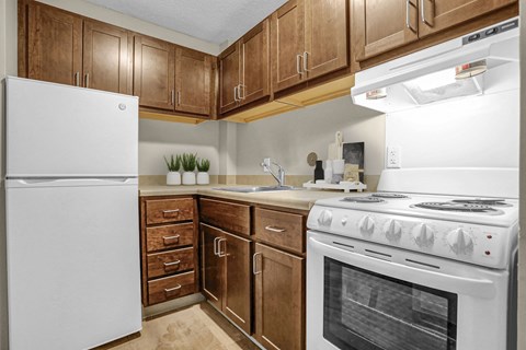 a kitchen with white appliances and wooden cabinets