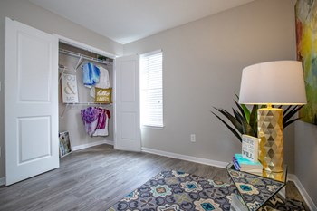 bedroom with model decor and window letting in natural light at The Mills at 601, Alabama - Photo Gallery 21