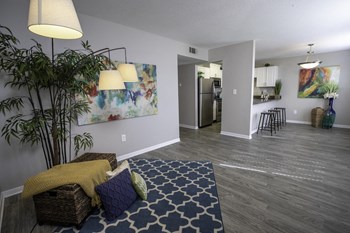 spacious living/dining room area with plank floors and model decor at The Mills at 601, Prattville - Photo Gallery 17