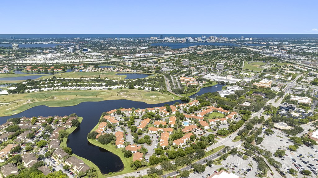 A bird's eye view of a residential area with a river running through it.