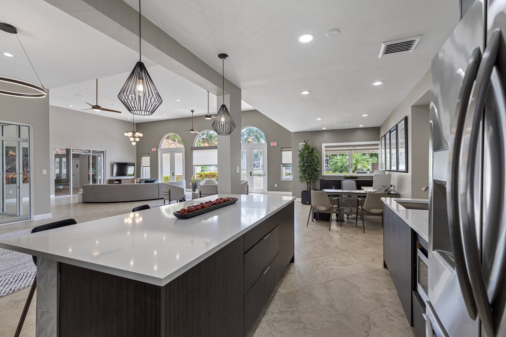 A modern kitchen with a large island and stainless steel appliances.