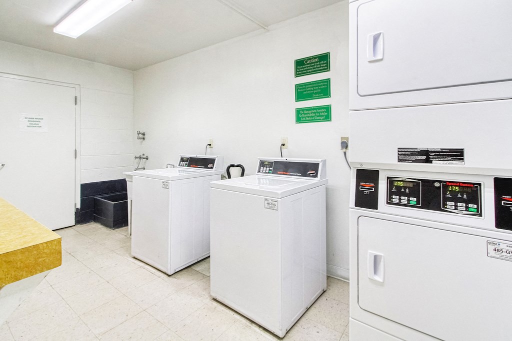 Laundry room with washers and dryers and shelf for folding