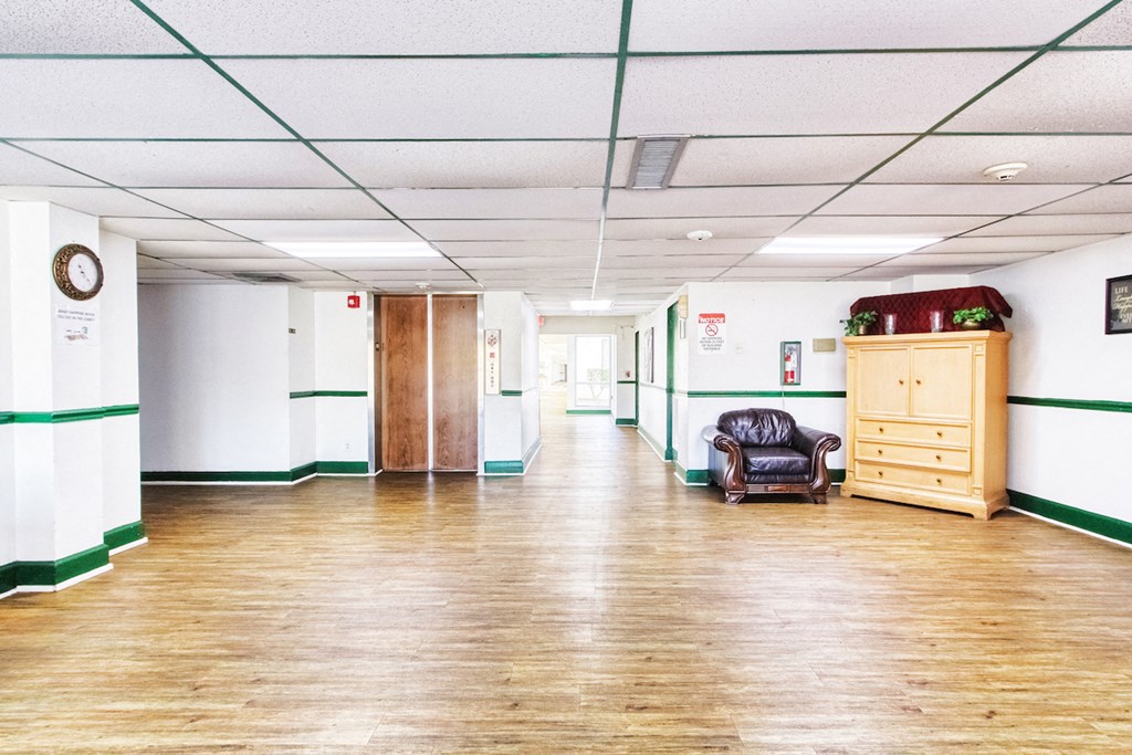 lobby area with elevator, comfortable chair for sitting