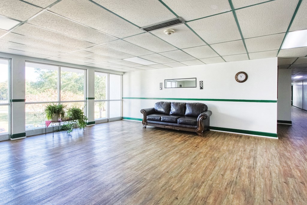 lobby with large windows and a couch for sitting