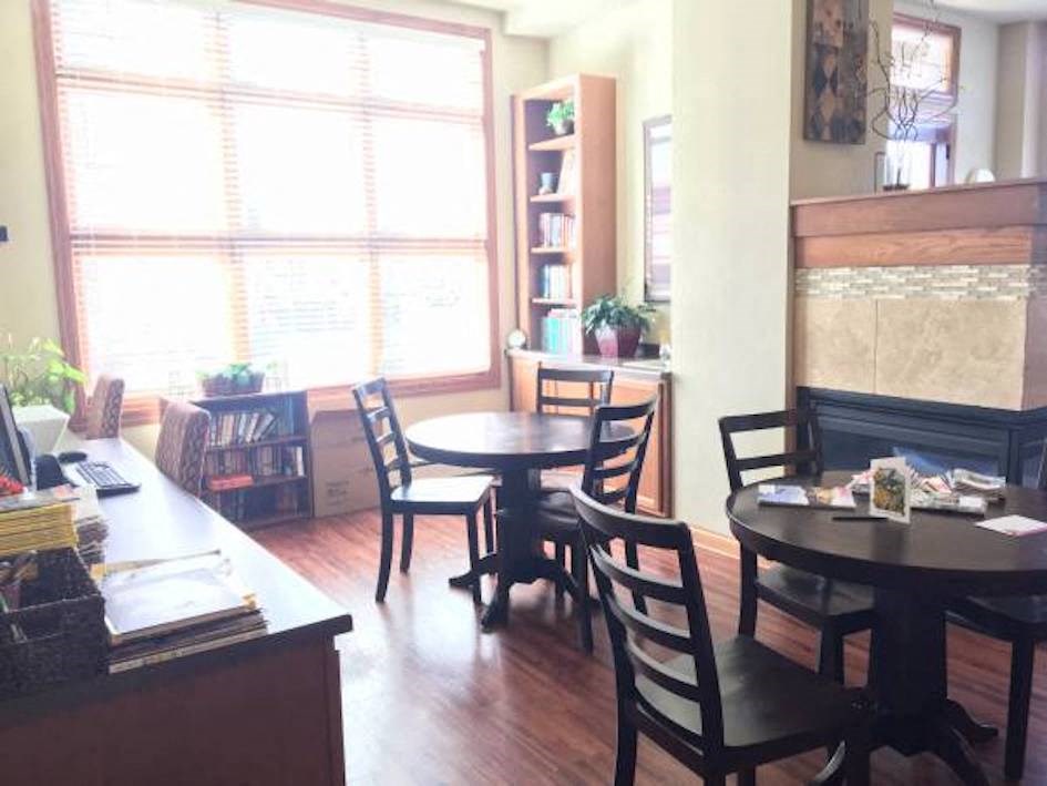 a room with a table and chairs and a fireplace