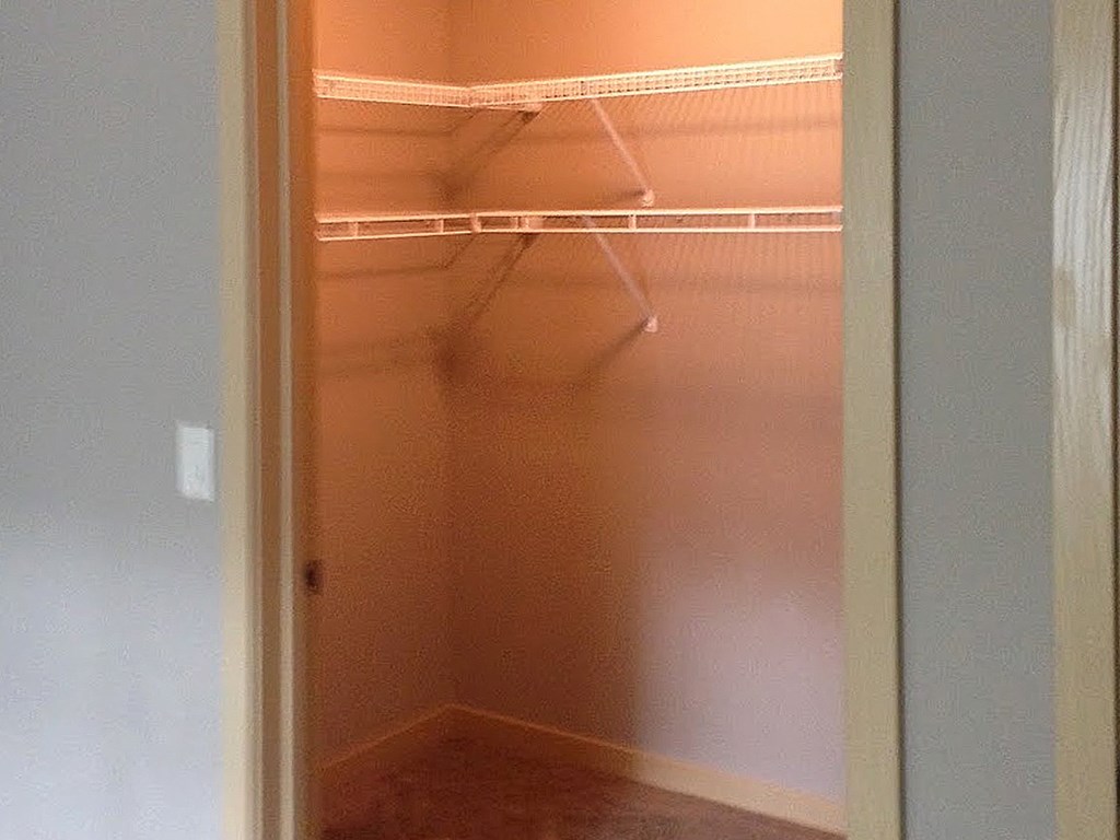 a walk-in closet with built in shelving in a Pioneer Ridge Apartment Home