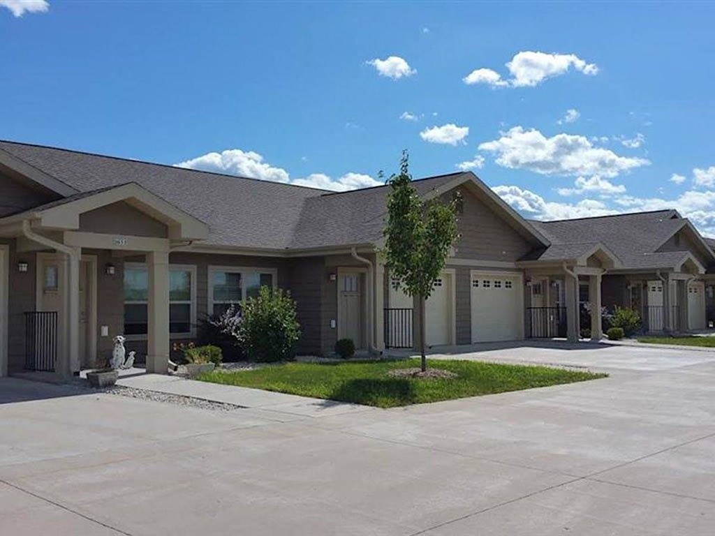 Rows of affordable apartment homes with attached garages at Pioneer Ridge in the Wisconsin Dells