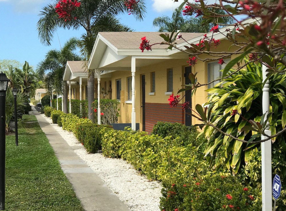well-kept apartment exteriors with tropical landscaping