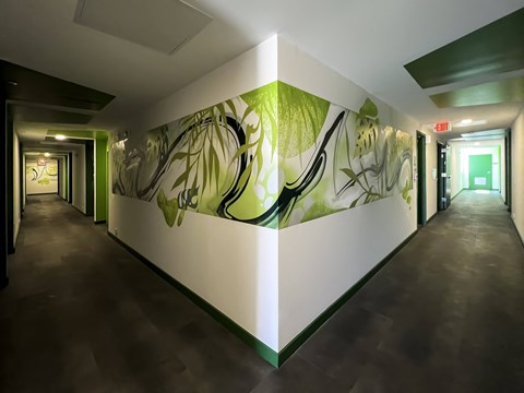 a beautiful green mural in a residential hallway at Citizen Birmingham