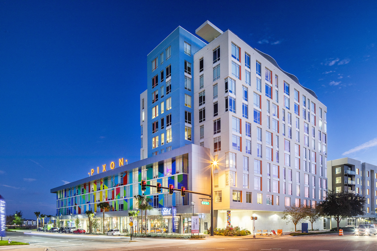 Lake Nona Pixon at desk with illuminated signage at Lake Nona Pixon, Orlando, FL