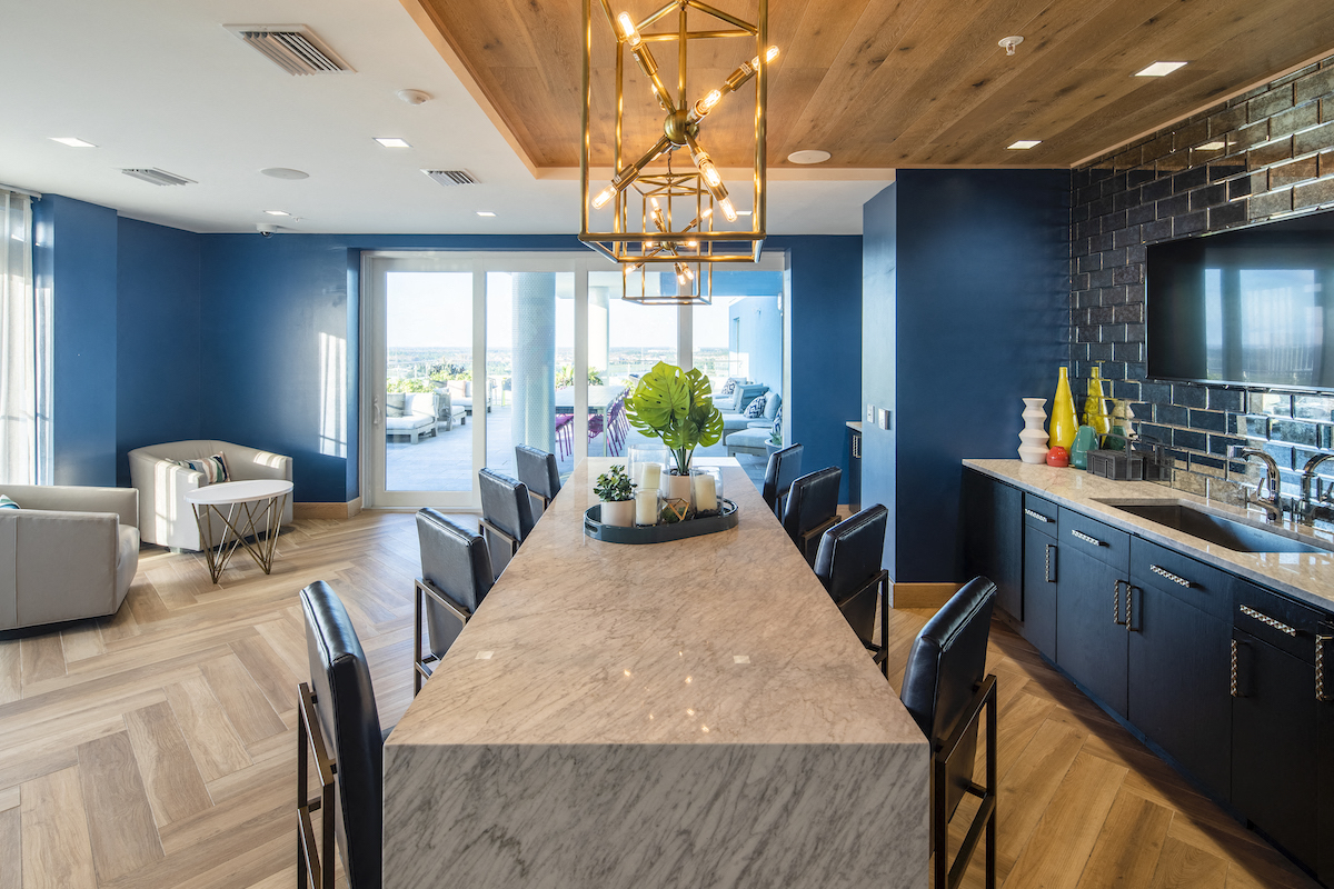 Indoor lounge with seating kitchenette and access to outdoor dining room at Lake Nona Pixon, Florida