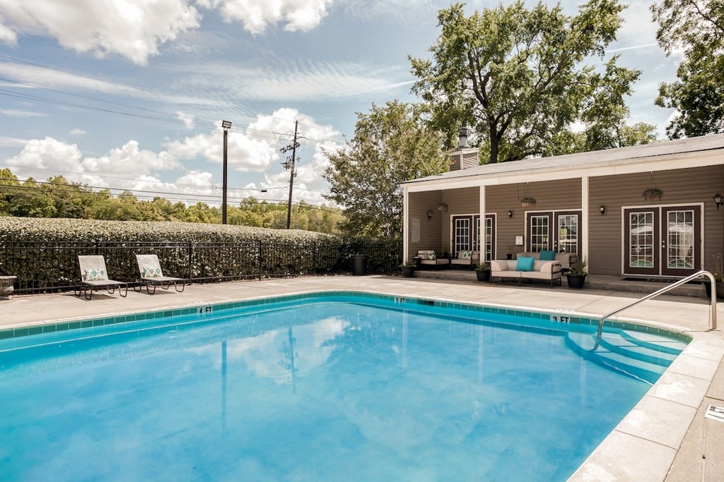 the swimming pool and sundeck behind the leasing office clubhouse at Trails at Alabaster Apartments