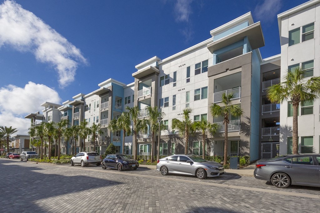 Cars parked along roadside in front of Residences at The Green Apartment homes