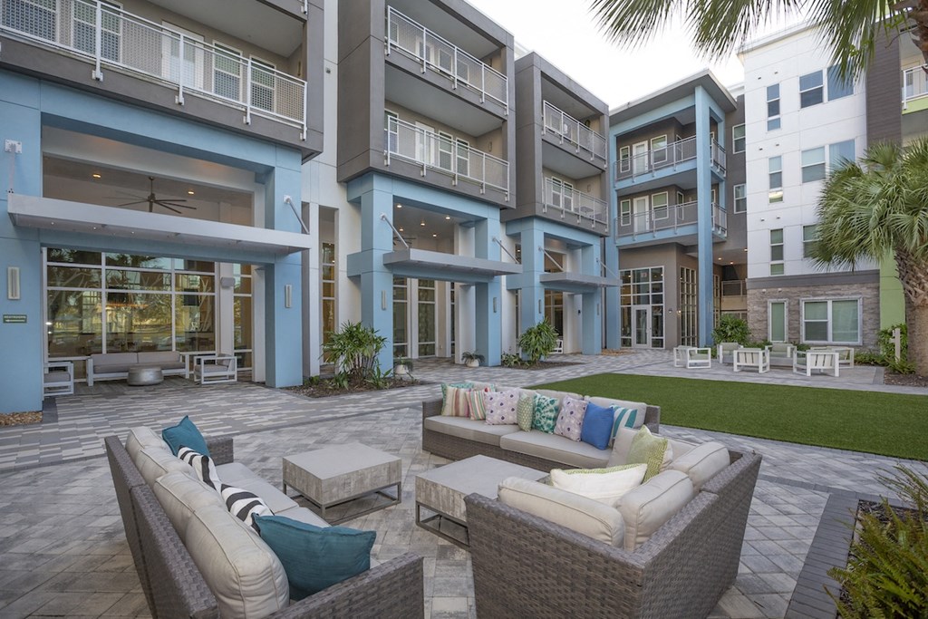 outdoor resident lounge with plush couches and chairs by The Green