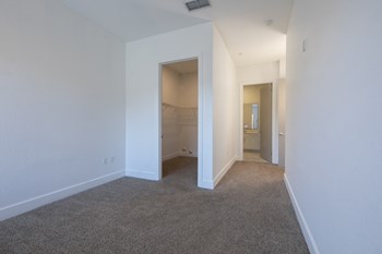 Bedroom with large walk-in closet with shelving and bathroom entrance in bedroomat Rise Lakeview Apartments in Birmingham, AL - Photo Gallery 9