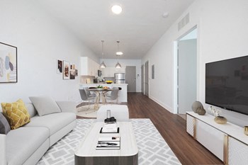 Large living area Large living area with hardwood-style floors, model decor, and open kitchen at Rise Lakeview Apartments in Birmingham, AL
