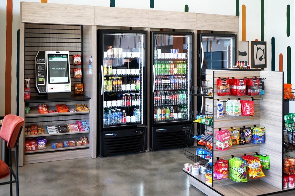 a convenience store with refrigerators and drinks and a vending machine at Citizen Birmingham Apartments