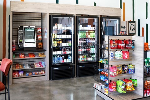 a convenience store with refrigerators and drinks and a vending machine at Citizen Birmingham Apartments