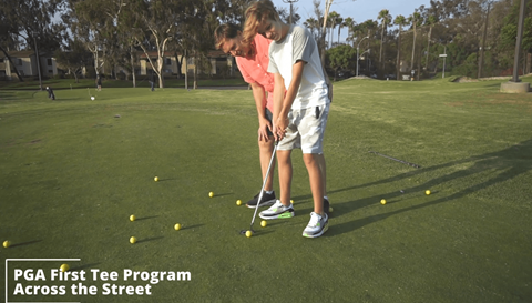 a pga first tee tee program across the street with two girls playing golf